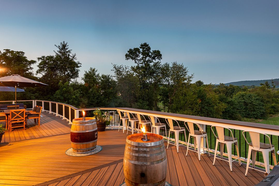 Bar-top railing with stools on a Utah deck at sunset
