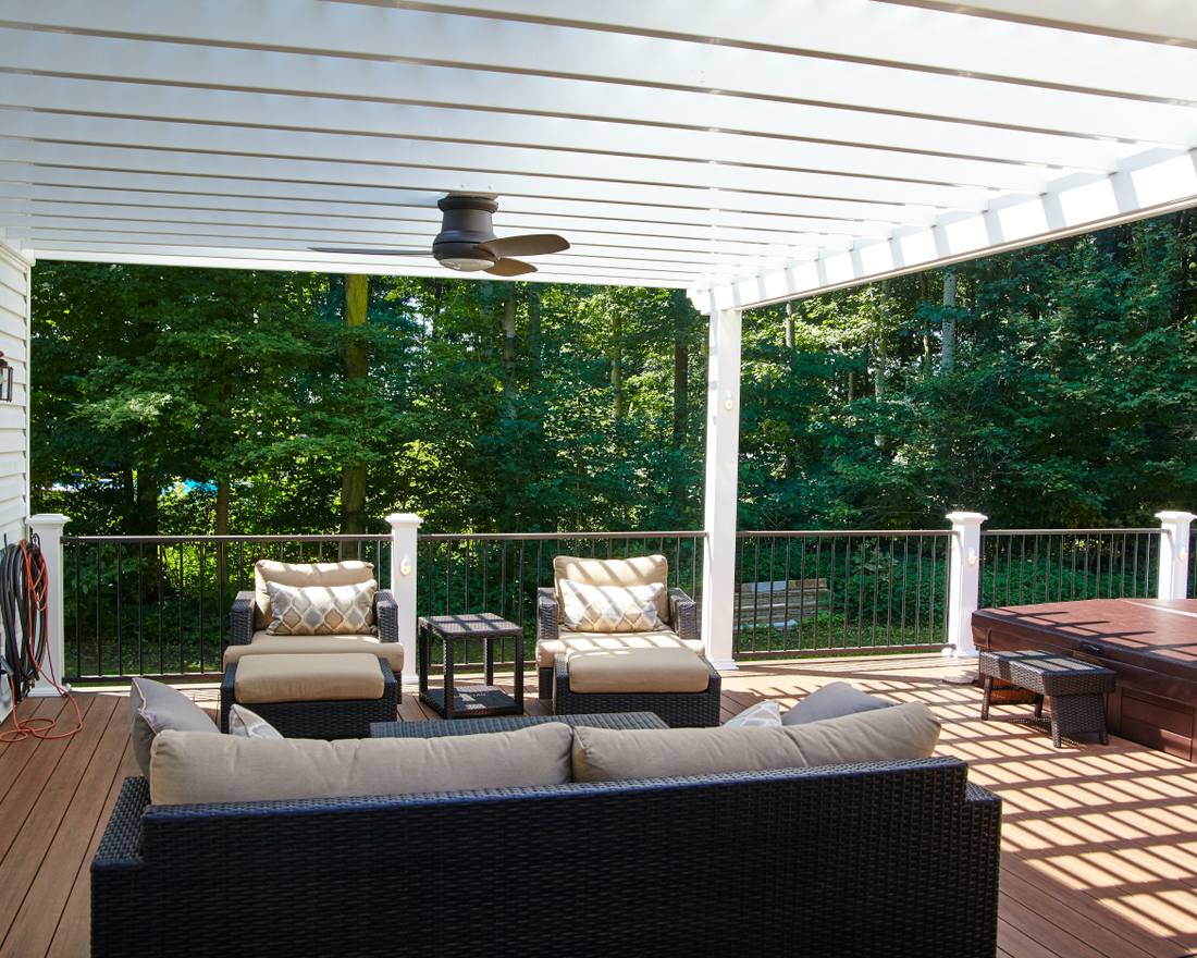 Covered composite deck with a white roof and ceiling fan