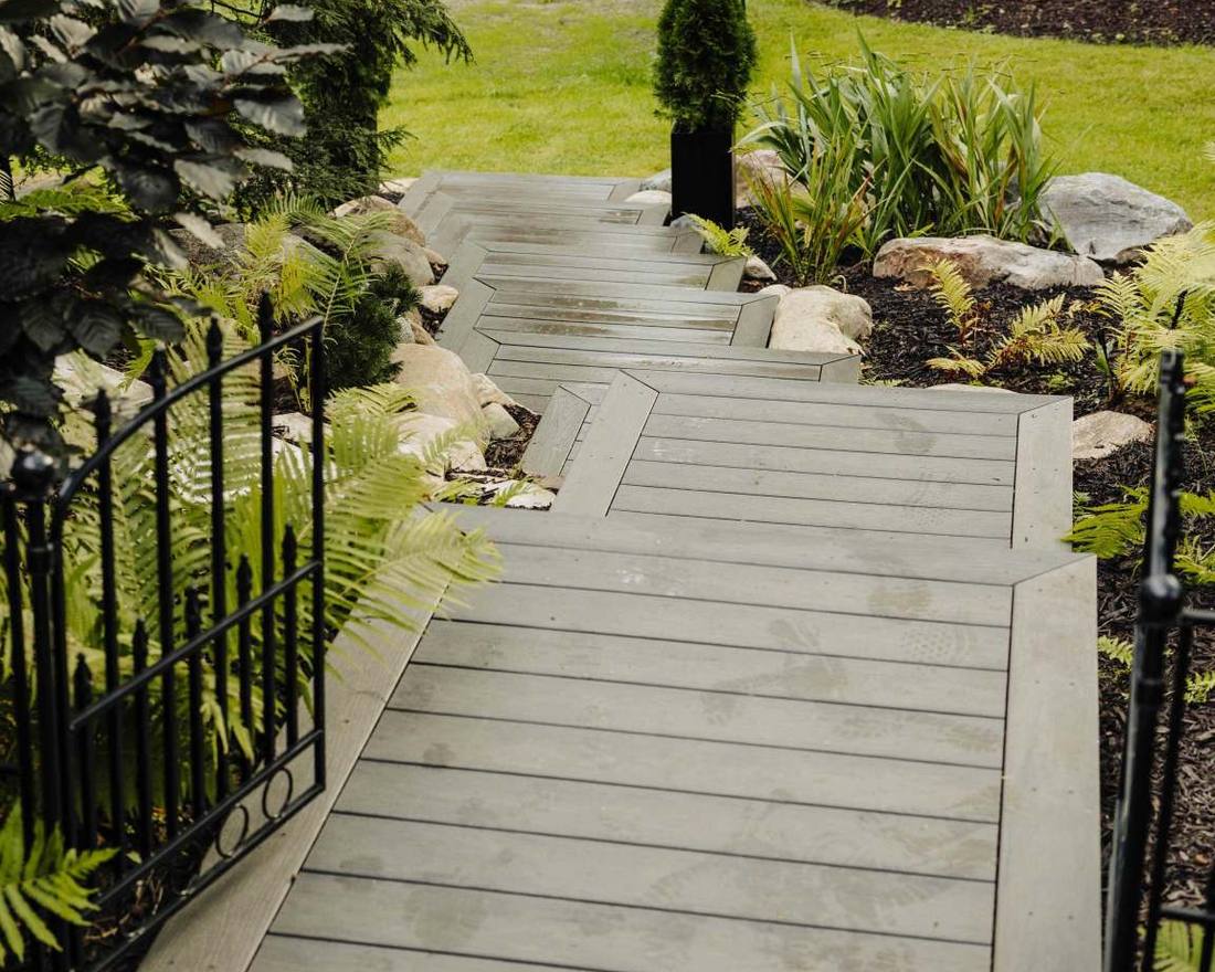 Composite walkway connecting a deck to the yard