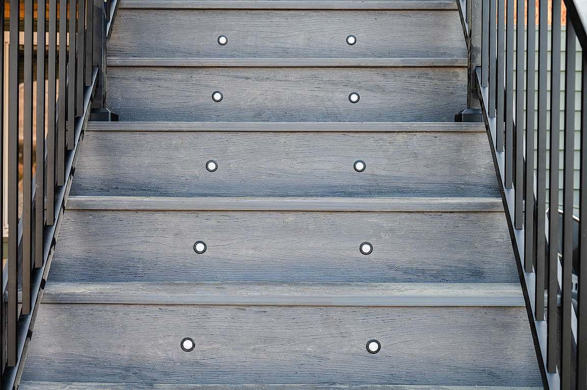 Composite deck stairs with tread lighting