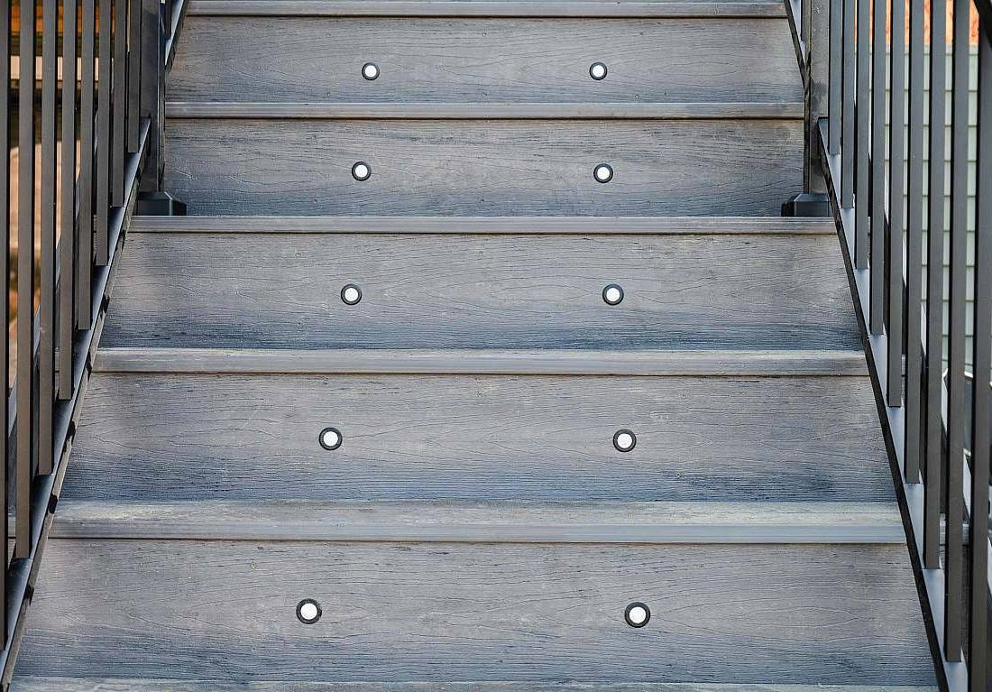 Composite deck stairs with tread lighting